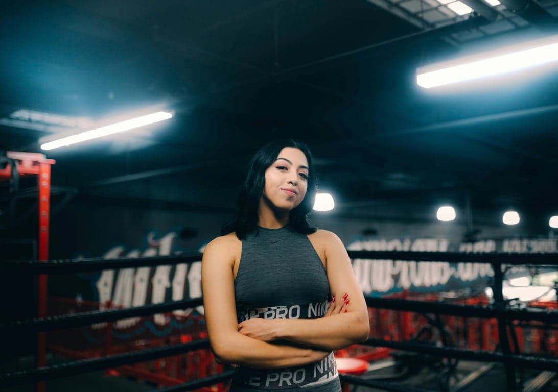 anime tattoo before photo - woman standing in a boxing field