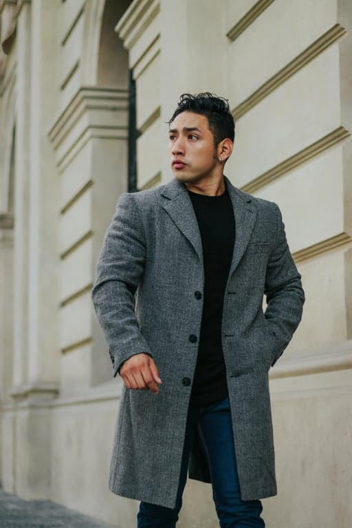 a portrait of a man, emotional sad edit, watery eyes, downturned mouth, cool desaturated color grade, dramatic shadows.