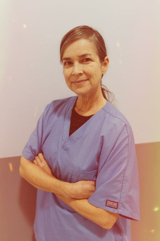 a portrait of a woman, 80s film grain filter, warm faded color palette, soft focus, subtle light leaks, nostalgic atmosphere.