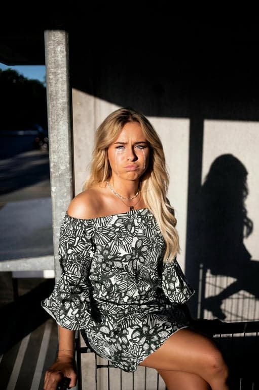 Generate a dramatically exaggerated sad expression that feels intentionally over-the-top and humorous, with fake-cry elements such as puffed cheeks, trembling mouth shape, overly glossy eyes, and theatrical facial tension, clearly signaling playful exaggeration rather than real distress.