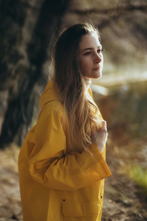 a portrait of a person processed to remove only non-natural light artifacts such as lens flare spots, streaks, and chaotic shadows, while keeping intentional facial lighting, realistic depth, and natural skin texture