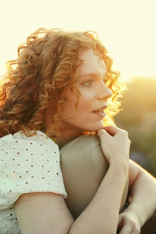 a portrait of a person styled as a clean Polaroid instant image with gentle color shifts and subtle film texture