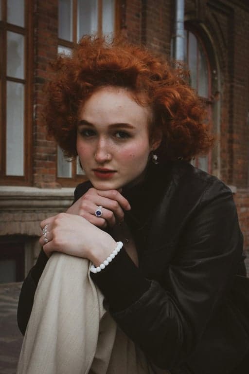 a portrait of a person with posture transformation that changes the original pose into a relaxed standing position: body upright, weight evenly distributed on both feet, shoulders naturally dropped and opened, chest gently lifted, spine elongated; arms resting naturally at sides or lightly bent; preserve body proportions and identity; avoid stiff military stance; do not modify the background; result should look like a naturally confident standing pose