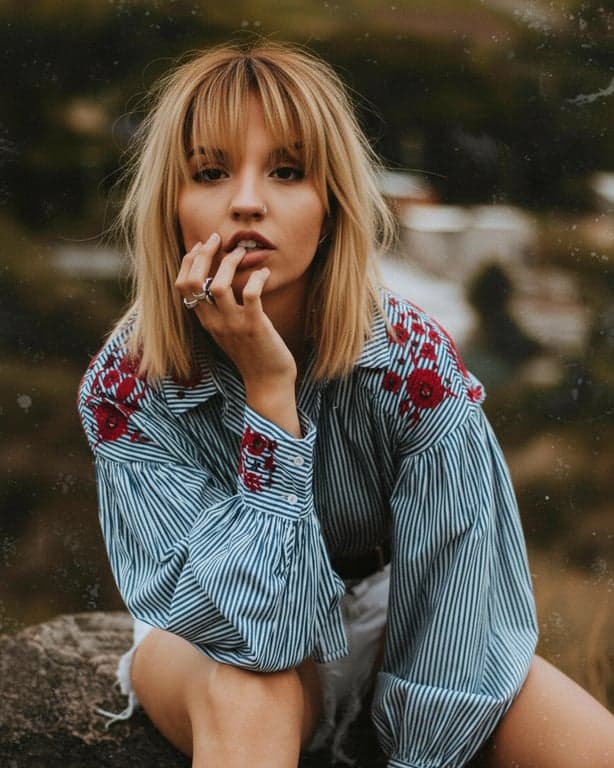 create a virtual fringe try-on result that looks like a real haircut, with soft layering, natural fall, and no visible compositing artifacts