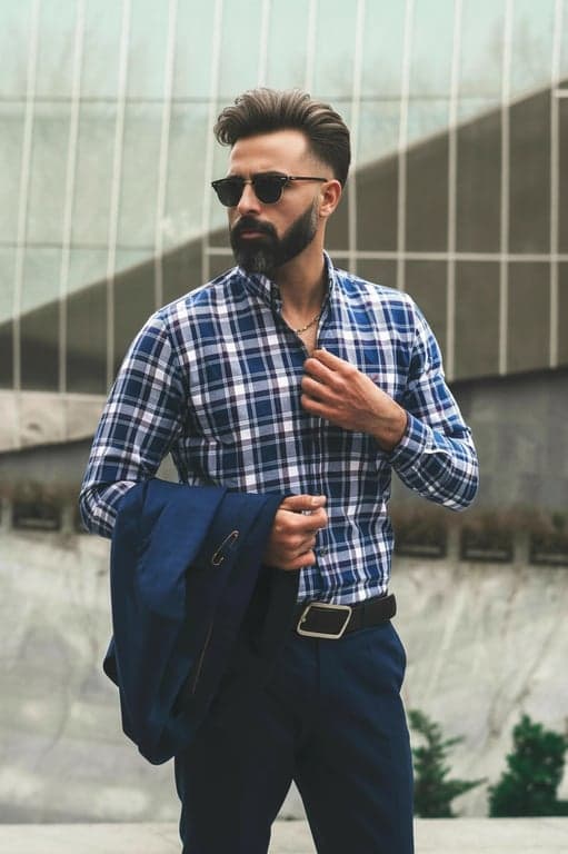 a portrait of a person refined to show increased hair volume through controlled density enhancement and root lift; preserve haircut structure and length; keep individual strands visible; avoid smoothing or over-styling; do not modify background, face, or posture; result should look like healthy, naturally thick hair