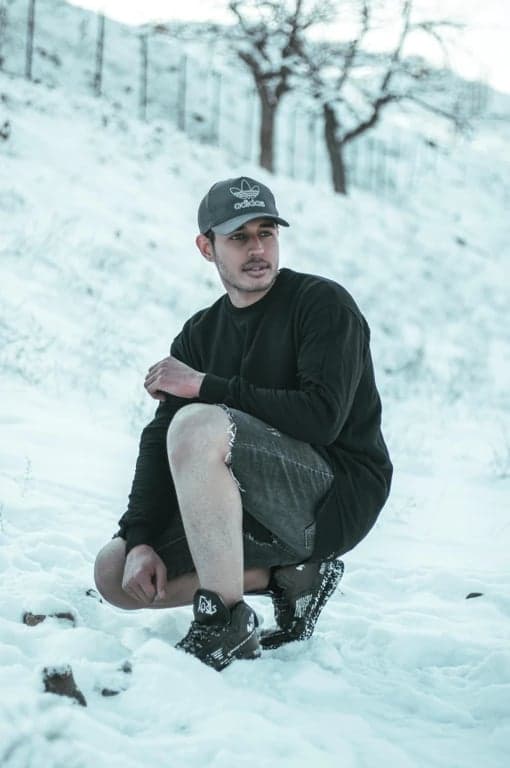 a portrait of a person edited to resemble a Demon Slayer anime illustration, featuring sharp facial features, stylized costume layers, and dynamic shadow placement