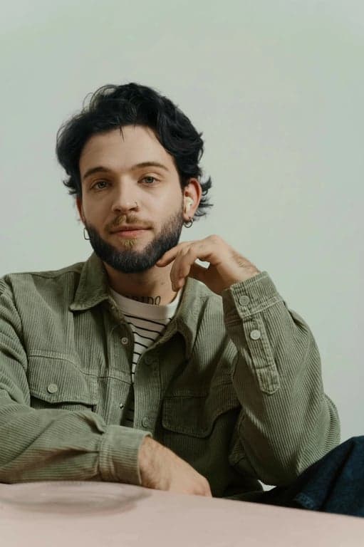 a portrait of a person transformed with black hair color, featuring deep neutral black tones, preserved highlights, visible strand separation, realistic shine, and natural root continuity