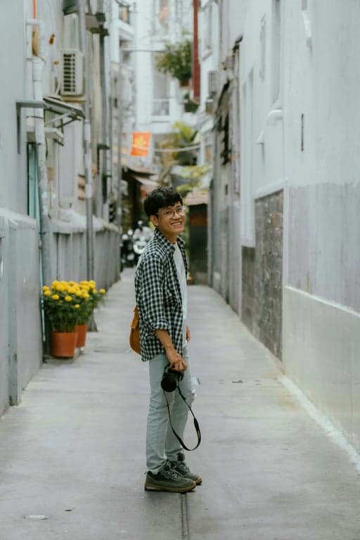 a portrait of a person enhanced with old camera aesthetics, featuring inconsistent exposure, subdued highlights, rough grain, and a worn photographic feel