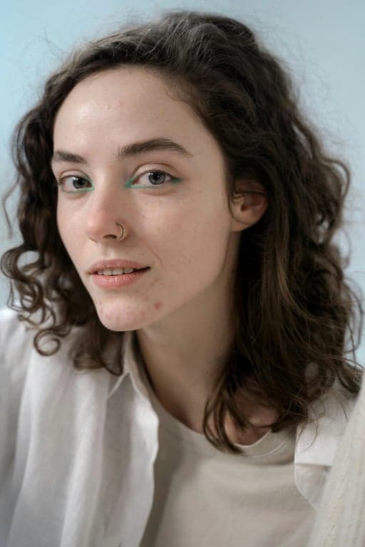 a portrait of a person illustrated as an anime hero character, featuring clean line art, vibrant but controlled colors, strong contrast lighting, simplified anime anatomy, and a confident heroic pose