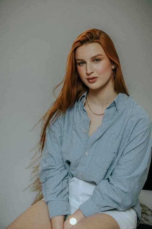 A portrait of a person converted into a My Little Pony-style animated pony with four hooves on the ground, compact rounded body, oversized eyes, mane adapted from original hairstyle, background preserved, flat pastel colors, clean cartoon outlines, and a cutie mark symbolizing the person’s defining trait.