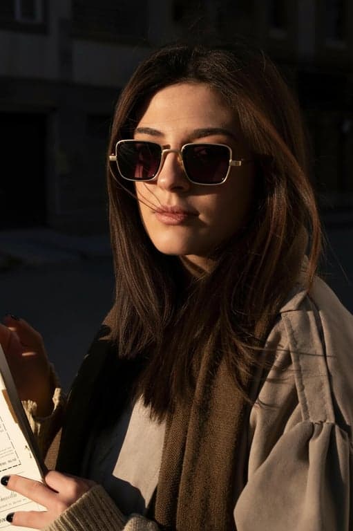 a portrait of a person enhanced with realistic jawline clarity by strengthening the visual jaw contour and reducing lower-face softness, introducing a firm, clean jaw edge; apply controlled shadow under the chin to create a stronger angular transition between face and neck; maintain facial symmetry and original proportions; avoid exaggerated angles or artificial edges; preserve ears, hairline, and neck contours; keep background unchanged; the face shape should look structurally improved