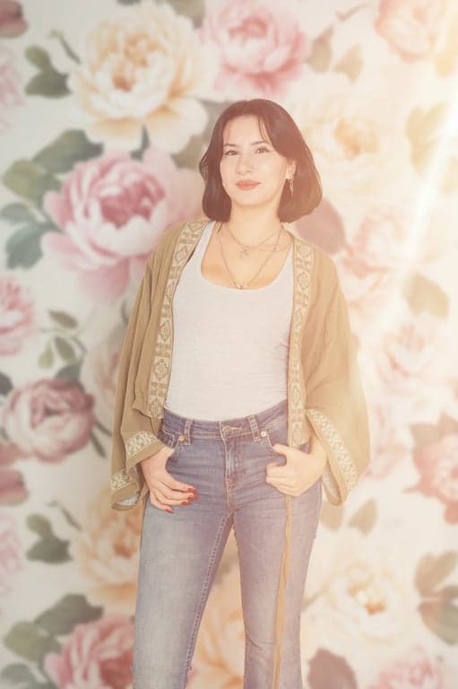 A dreamy soft light portrait of a woman, Instagram filter style, hazy light leaks, lowered saturation, romantic and soft aesthetic, floral background.