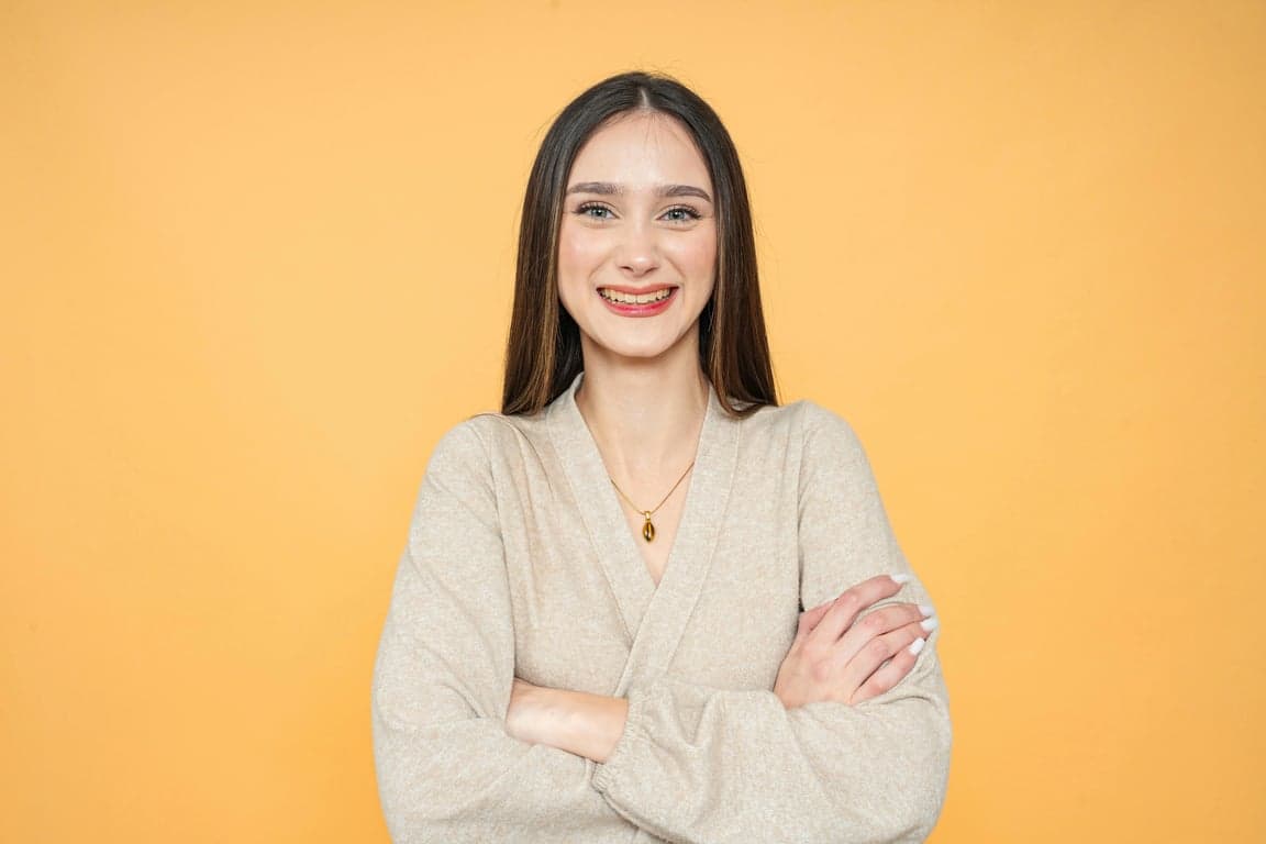 a portrait of a person reimagined in a My Hero Academia–inspired anime art style, with strong clean linework, expressive large anime-style eyes, simplified yet recognizable facial features that preserve identity, and a heroic youthful appearance; apply cel-shaded coloring with clear light and shadow separation; lighting should be dramatic and directional, simulating anime key light from above or side with strong highlights and defined shadows; color palette vibrant but controlled, avoiding over-saturation; background simplified into anime-style gradient or abstract action backdrop; composition half-body or head-and-shoulders, slightly dynamic pose if possible; clothing redesigned into anime-style hero outfit or school-uniform-inspired costume with clear shapes and bold color blocks; final result should resemble a polished My Hero Academia character illustration, not a generic anime filter