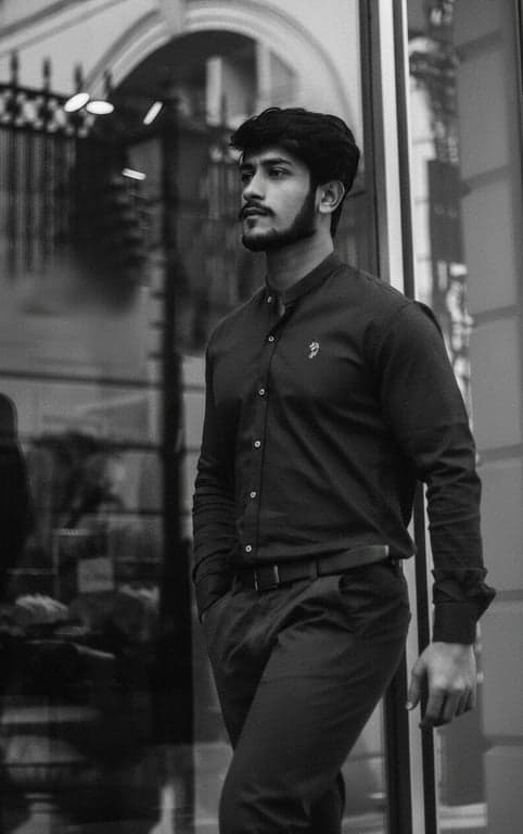 a portrait of a man, high contrast filter, deep black shadows, bright white highlights, sharp details, gritty texture.