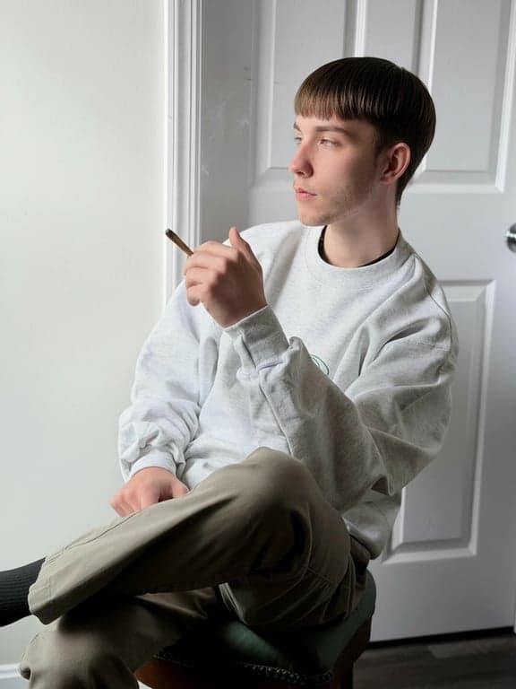 a portrait of a man edited in a clean Korean short haircut style, so that all hair is cut short and straight, with the top slightly longer than the sides following Korean salon proportions, no fringe covering the forehead, no curls or waves, a clearly defined hairline, and unchanged face and original lighting