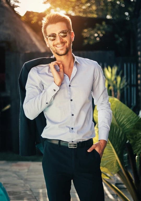 A warmly filtered environmental portrait of a man, harmony between warm subject lighting and cool background tones, balanced contrast, natural golden hour ambiance.