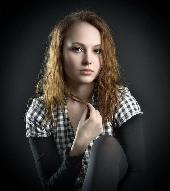 ai eye contact correction after photo - woman with cutly hair corrected to look directly at the camera