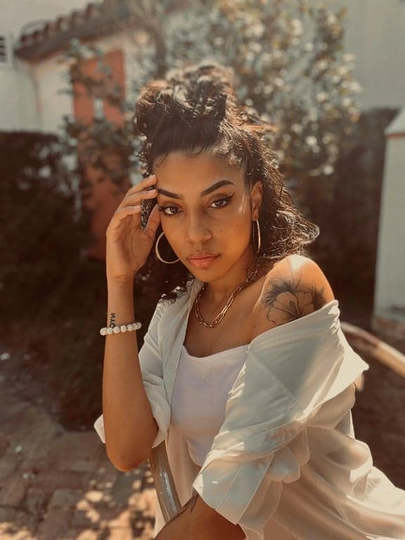 a portrait of a person edited into a shonen anime protagonist look, featuring exaggerated facial expression, sharp eyebrows, defined jawline, simplified anime facial planes, dynamic posture, and vibrant anime color palette