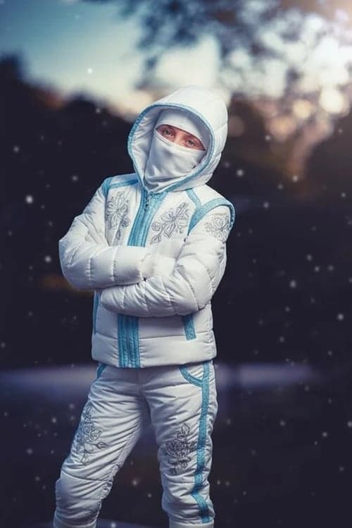Kids ninja after – child wearing a cozy snow ninja outfit for winter play