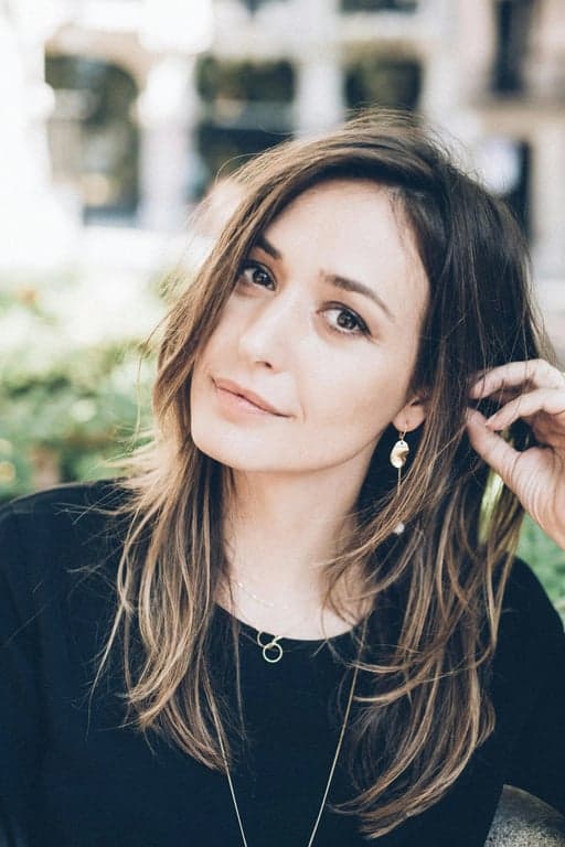 a boho-style braided hairstyle with loose, textured braids, natural wave patterns, and strands falling freely around the face for a relaxed, laid-back look