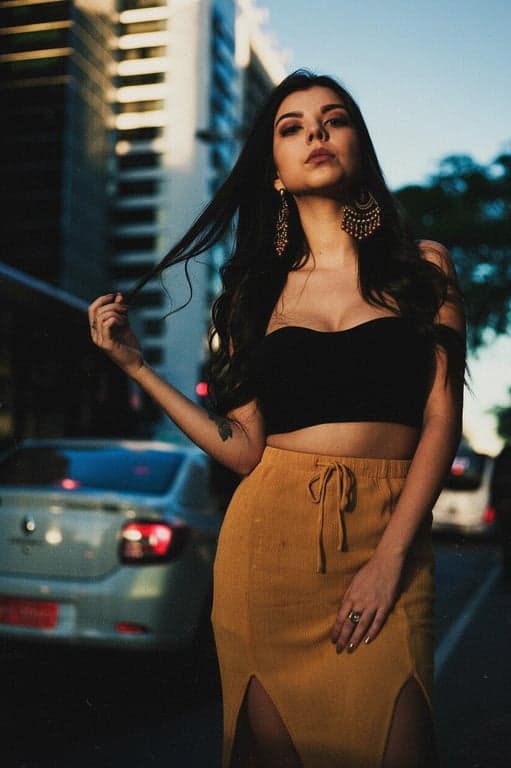 a portrait of a woman with a sepia-toned film grain effect, adding warm brown tones, paper-like texture, and light leaks