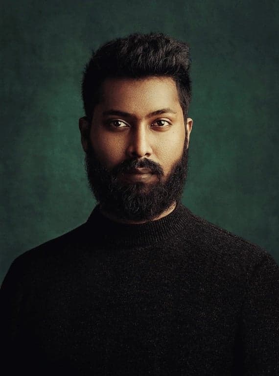 AI green screen remover before photo - man in black turtleneck posing against green background