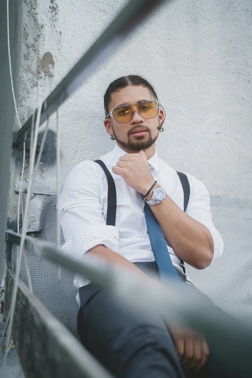 a portrait of a person photographed at eye level in a head-and-shoulders crop; increase hair volume only by enhancing strand density and fullness at the crown and mid-length areas; lift roots slightly to create visible thickness; preserve original hairline shape, hairstyle, and hair length; do not modify face, pose, background, or clothing; avoid inflated, helmet-like hair shapes; maintain realistic strand separation, flyaways, and natural hair flow; lighting unchanged; result should look like naturally fuller hair, not restyled hair