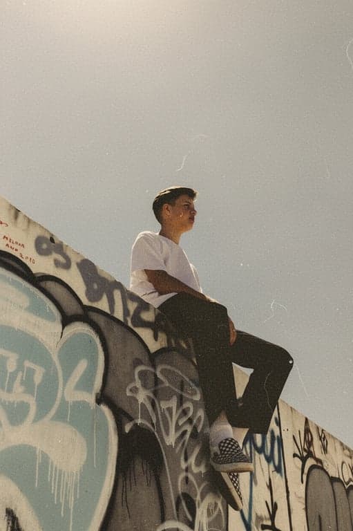 a portrait of a person edited to resemble an aged photograph taken with an old camera, emphasizing film grain and color shift