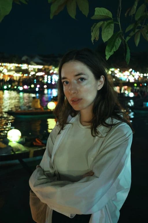 a portrait of a woman with the background changed to a rich burgundy color, evoking a sense of luxury and sophistication