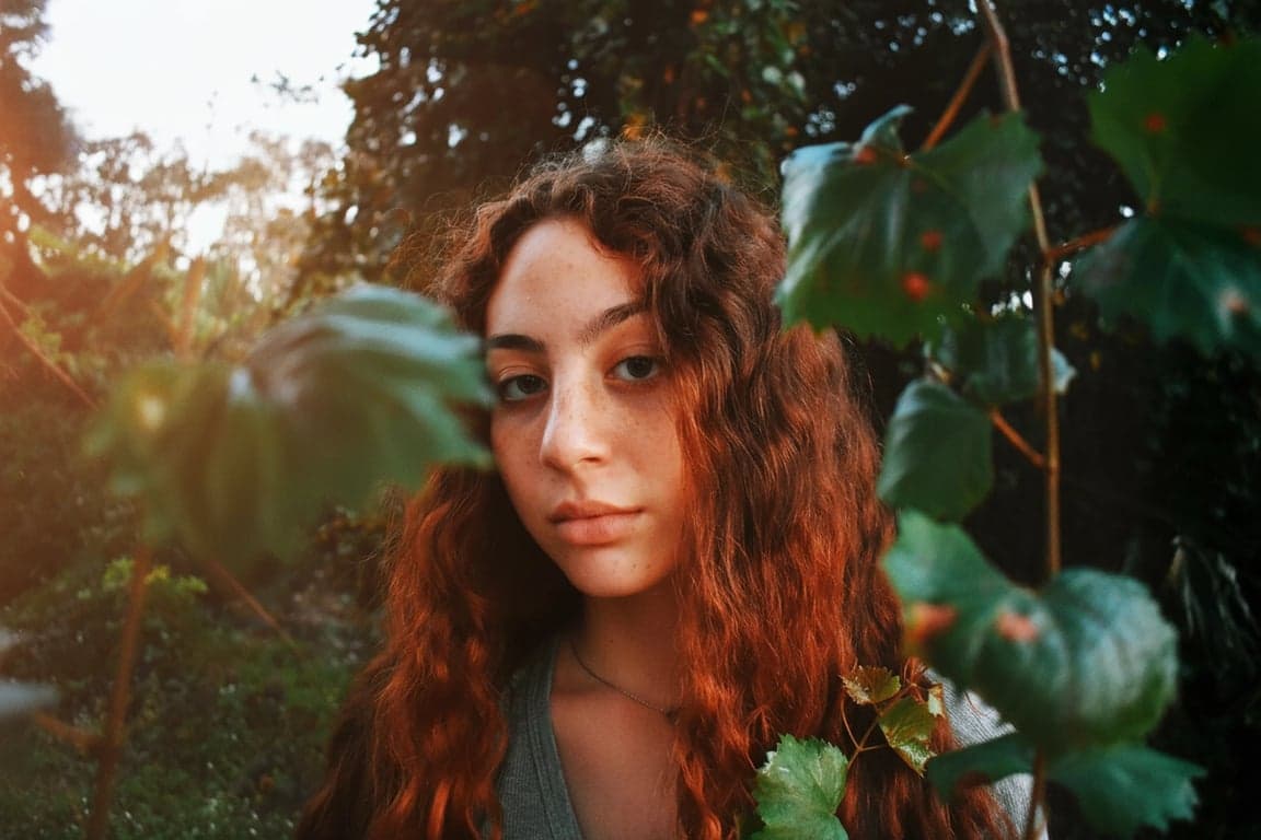 a portrait of a person with natural face lighting preserved, while messy lens flare, glare spots, and uneven shadow artifacts are carefully removed for a clean and clear look
