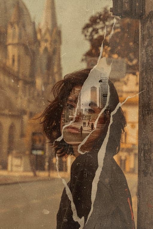 A portrait where the subject's face is partially blended with a peeling vintage poster or paint, revealing another image underneath, for a urban decay aesthetic.