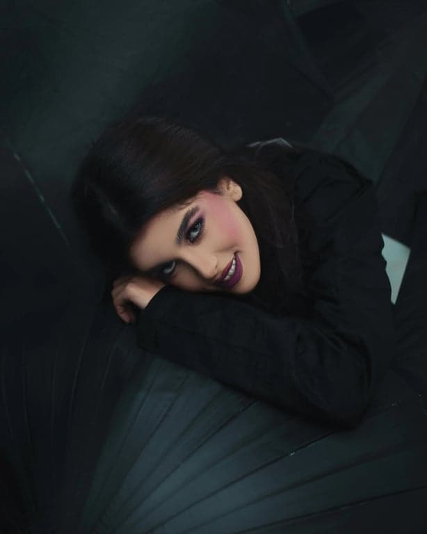 a portrait of a person edited with sunset-inspired lighting, including warm highlights, gentle contrast reduction, neutral shadows, and natural skin tone preservation