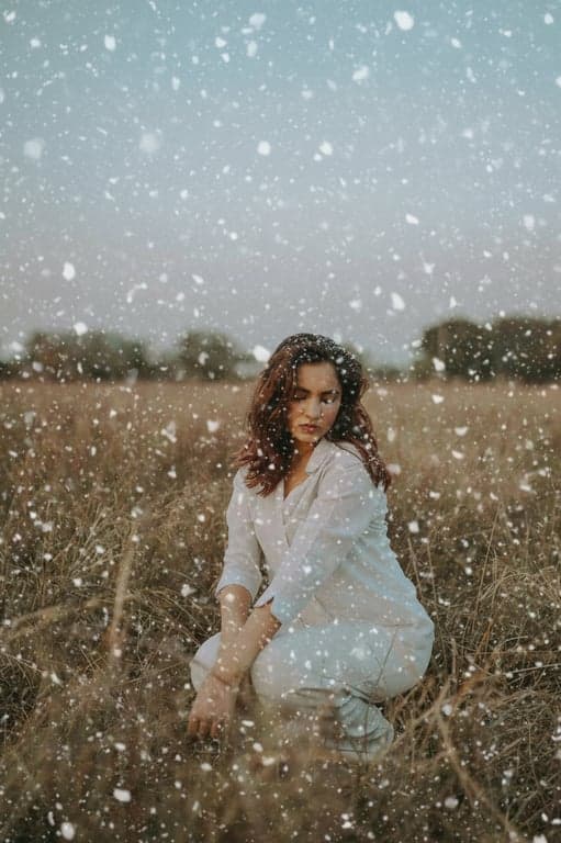 add snow that responds to lighting in the original image, reflecting highlights and fading naturally in shadowed areas to avoid flat overlay appearance
