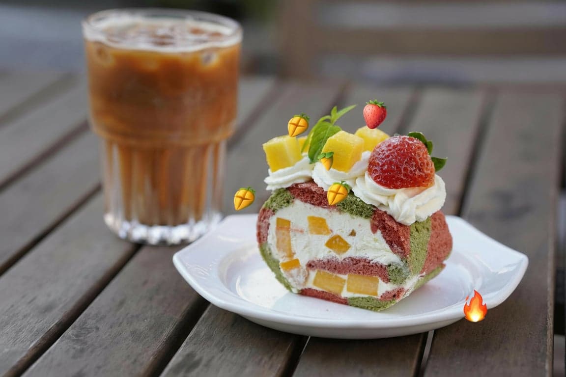 A food photo where emojis are used to label or highlight ingredients: a 🧀 emoji on the cheese, a 🍅 emoji on the tomato, and a 🔥 emoji to indicate spiciness.