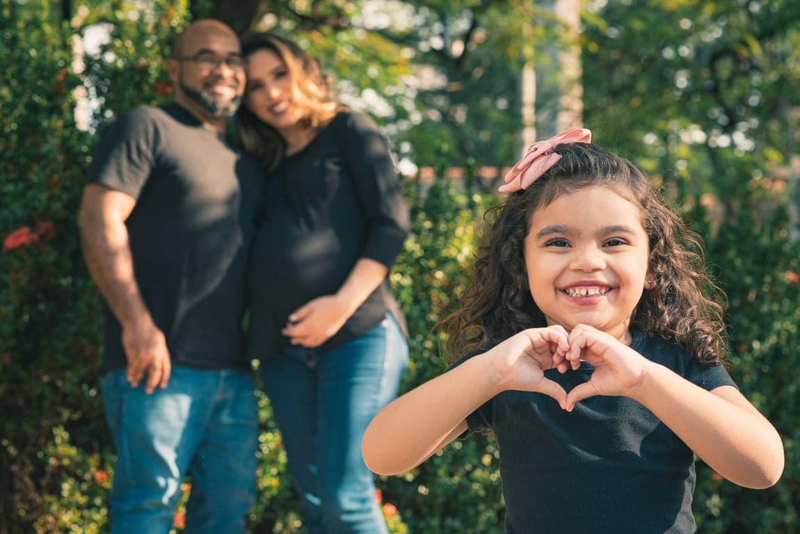 a portrait of a family transformed into a party-themed family portrait, wearing festive coordinated outfits, placed in a decorated celebration environment with balloons, banners, and soft ambient lighting, using cheerful poses, playful gestures, and lively expressions to create a joyful family celebration scene