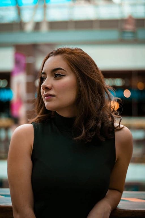 a portrait of a person transformed into a DC Comics–style comic book illustration featuring strong angular facial structure, sharp jawline, defined cheekbones, bold black ink outlines, high-contrast comic shading, muscular visual tension, saturated but controlled colors, and a dramatic superhero comic atmosphere