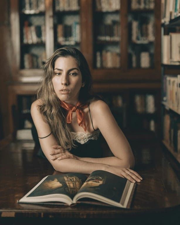 AI big eyes filter before photo - woman sitting at the desk