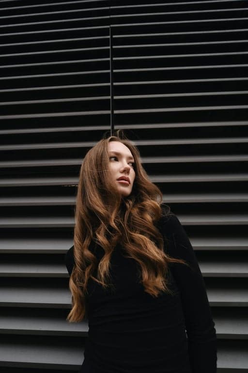 Complete the full-body view of the person by extending the image downward while keeping lighting direction, exposure, and perspective consistent from head to toe. Ensure hands, legs, and feet are anatomically correct and visually connected to the original upper body.