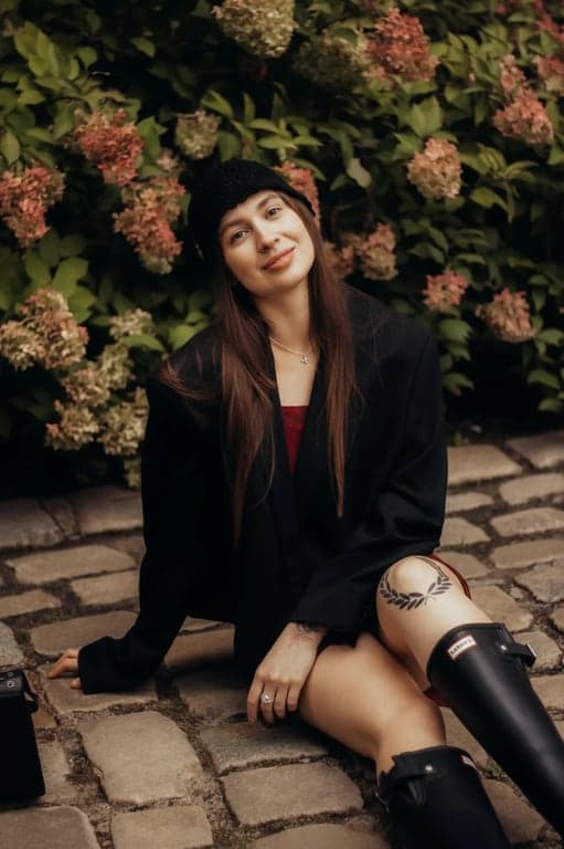 transform the image into a dating app photo by improving lighting direction, clarifying facial features, refining jaw and cheek contours in a noticeable but believable way, enhancing eye focus, simplifying background clutter, preserving identity and skin texture, and presenting the subject with a confident approachable expression that reads as authentic and clearly improved from the original