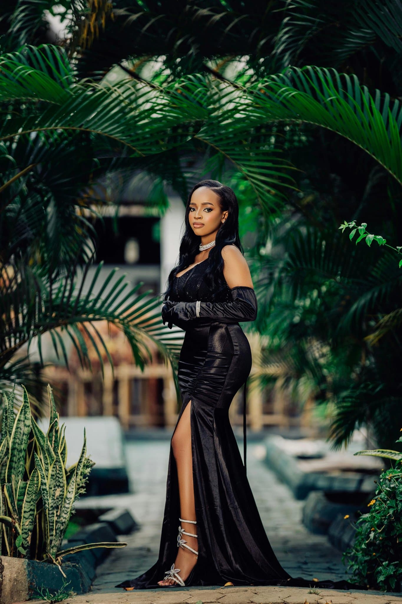 A full-body photo of a person wearing dark or neutral colored clothes.