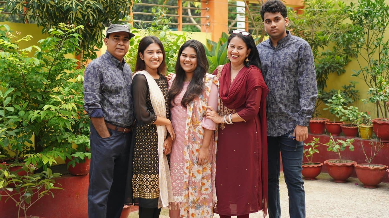 a clipart scene of a diverse family holding hands in a circle around a house, and a separate scene of two friends high-fiving, in a cartoon style with warm colors.