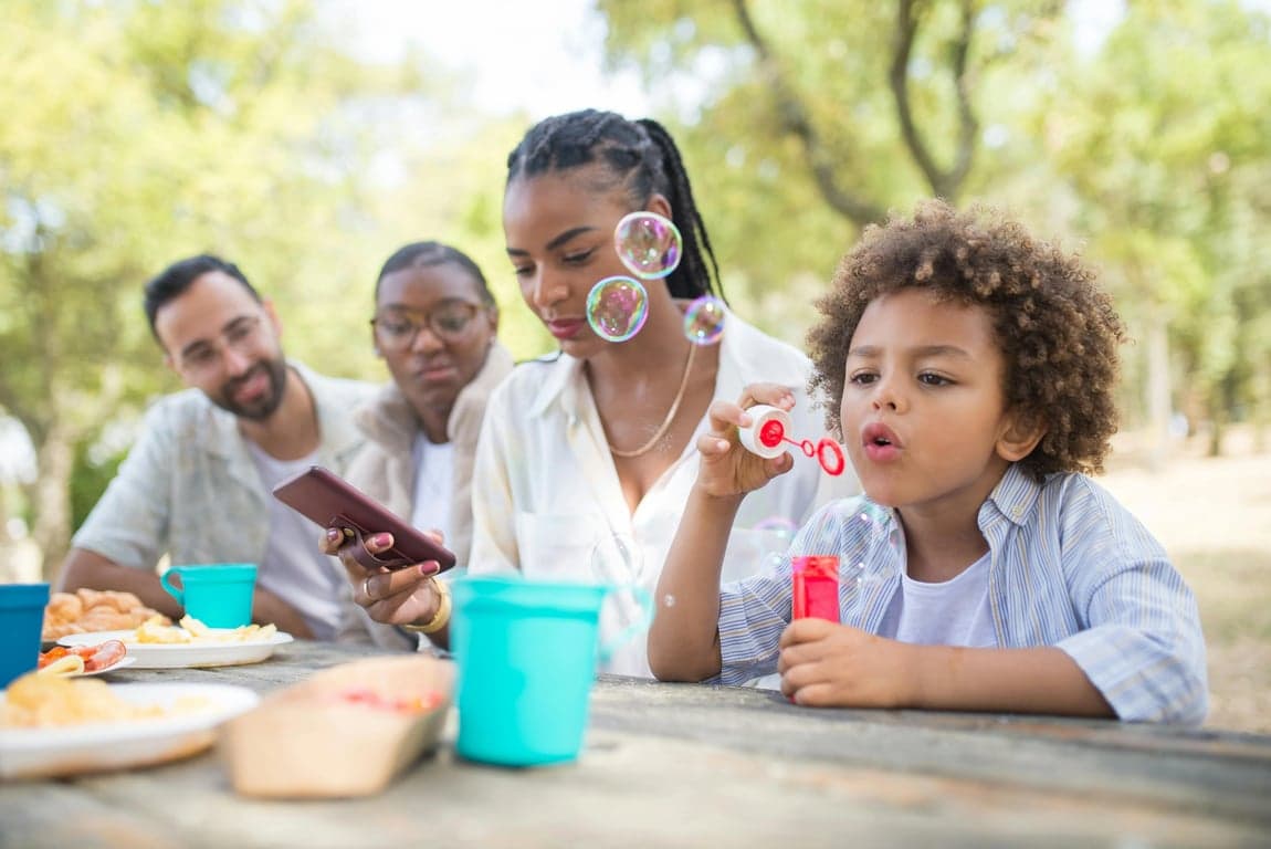 a portrait of a family transformed into a spring-themed family portrait, all members dressed in light pastel outfits with fresh colors, placed in a bright spring environment with blooming flowers and greenery, using open gentle poses and light smiles to create a fresh optimistic family scene
