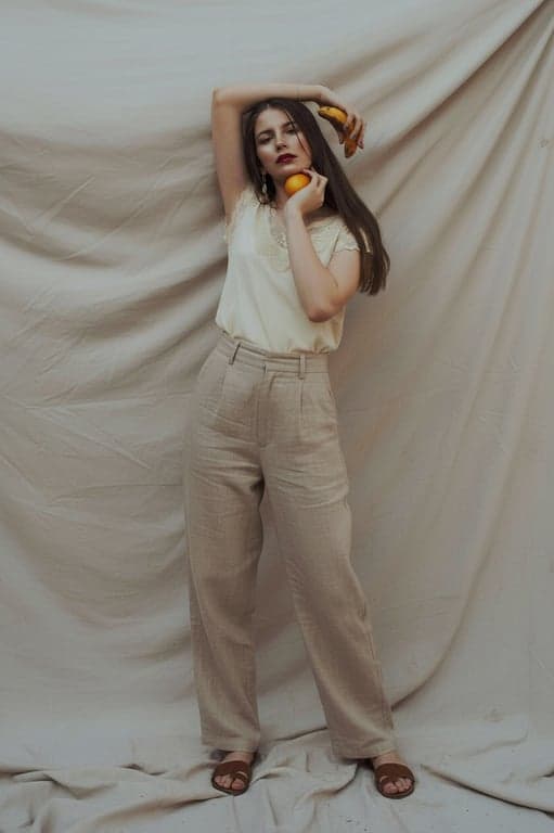 Rebuild the missing lower body of the person while preserving original posture and body balance. Ensure accurate weight distribution, natural standing mechanics, and smooth transitions between the original image and the reconstructed areas.