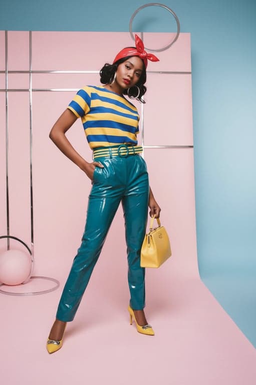 A product still life mimicking 1950s advertisement photography, featuring shiny chrome and bold plastic colors against a clean, minimalist pastel background.