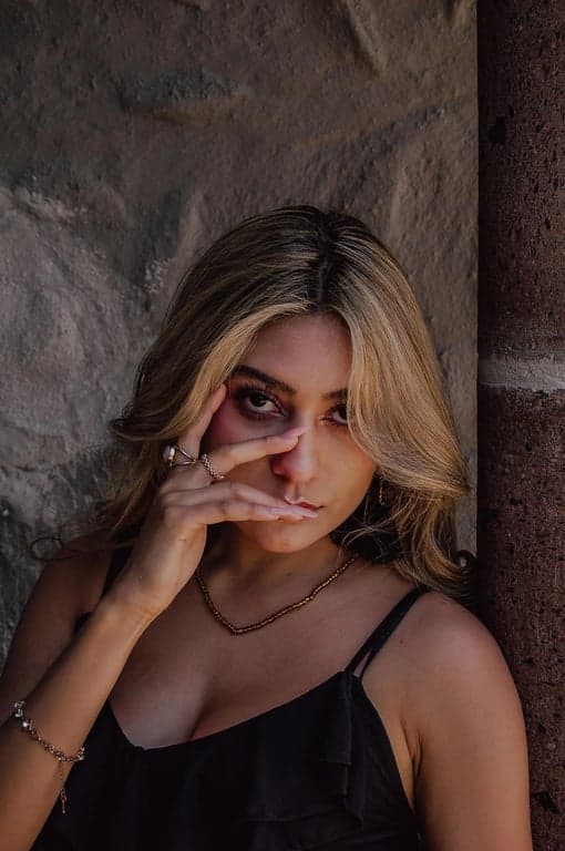 Reconstruct the full body of the person based on the original image, preserving identity, clothing, and environment. Complete the missing anatomy with realistic human proportions, stable stance, natural limb length, and seamless visual alignment from torso to feet.