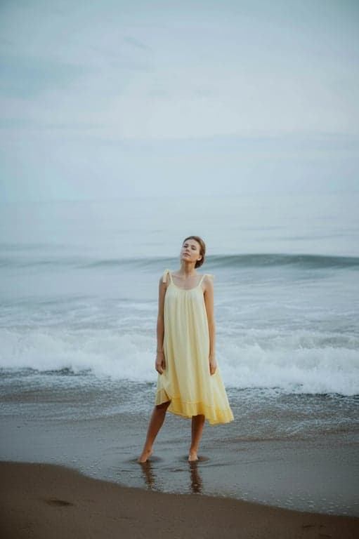 a portrait of a person edited to adopt a casual standing posture with one leg slightly relaxed, subtle hip shift, open chest, and natural spinal curve; shoulders released, neck elongated; preserve realistic body mechanics and clothing behavior; do not alter background; posture should read as calm and self-assured