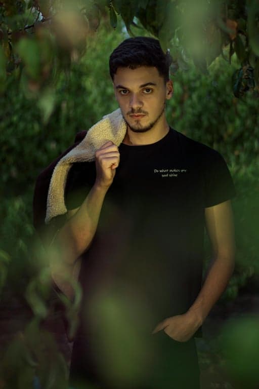 a fully reimagined Looney Tunes–inspired cartoon illustration of the person, drawn anew using classic animation principles rather than applying a visual filter, focusing on performance-driven facial expressions, elastic squash-and-stretch body proportions, simplified yet dynamic anatomy, bold contours, bright saturated vintage colors, smooth painted shading, and exaggerated slapstick character acting.