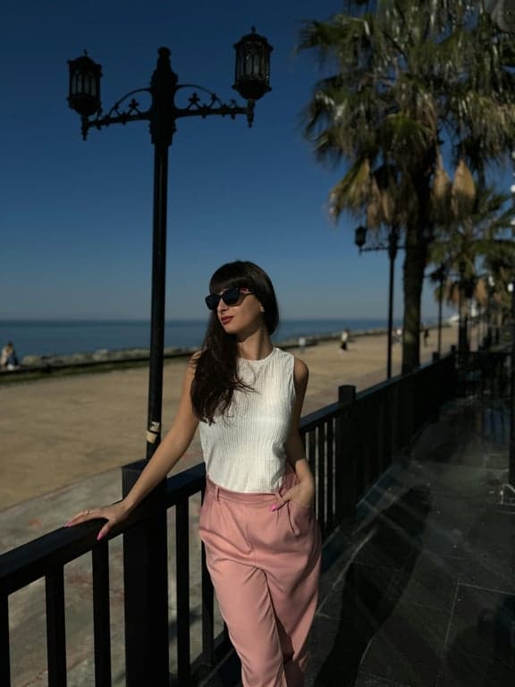 A beach sunset photo where the existing sun is enhanced to be larger and more dramatic, with intensified reflection on the water and richer sunset colors.
