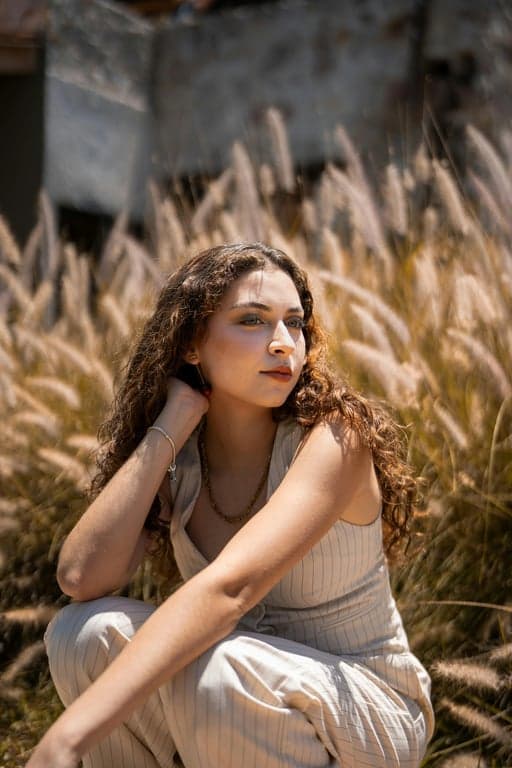 a portrait of a person transformed into an old film camera photo with grainy texture, muted saturation, and vintage softness