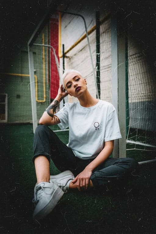 a portrait of a woman edited with a Lomography-style film grain, featuring vibrant colors, vignetting, and chunky grain texture